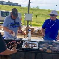 Alumni cooks at grill